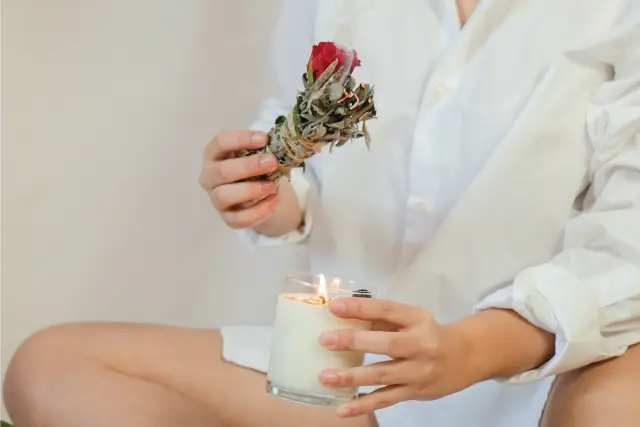 woman smudging with candle